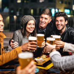 happy-friends-group-drinking-beer-at-brewery-bar-outdoors.jpg